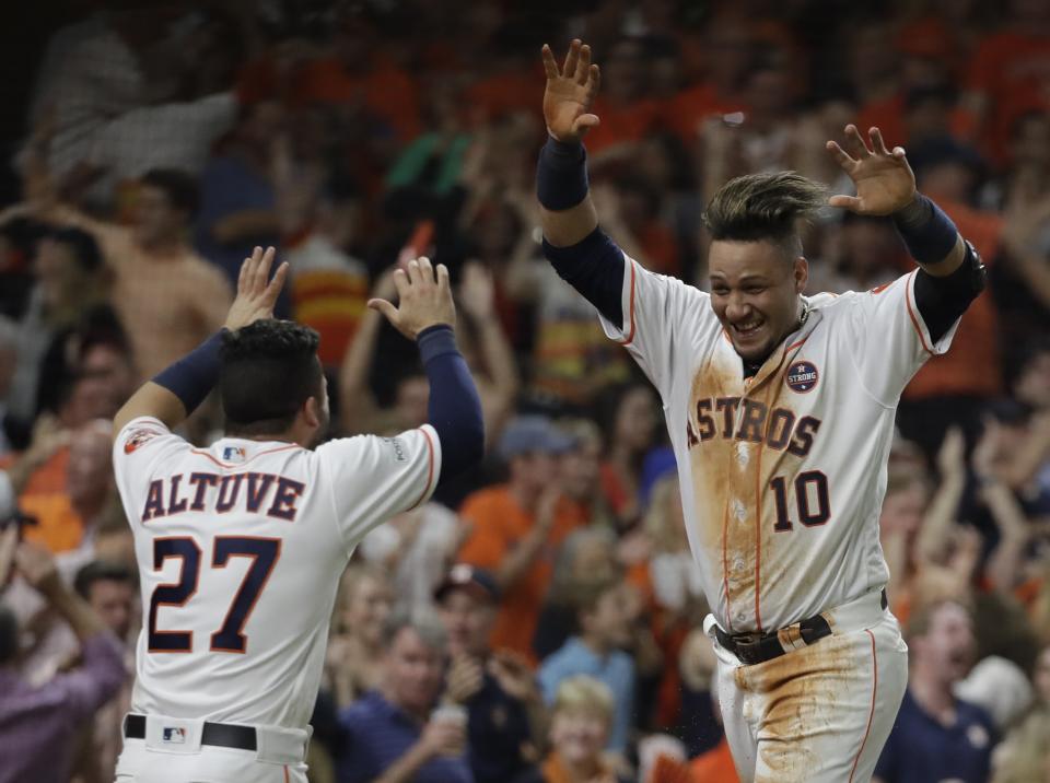 Houston Astros’ Yuli Gurriel is congratulated by Jose Altuve after scoring during the fifth inning of Game 7 of baseball’s American League Championship Series against the New York Yankees Saturday, Oct. 21, 2017, in Houston. (AP)