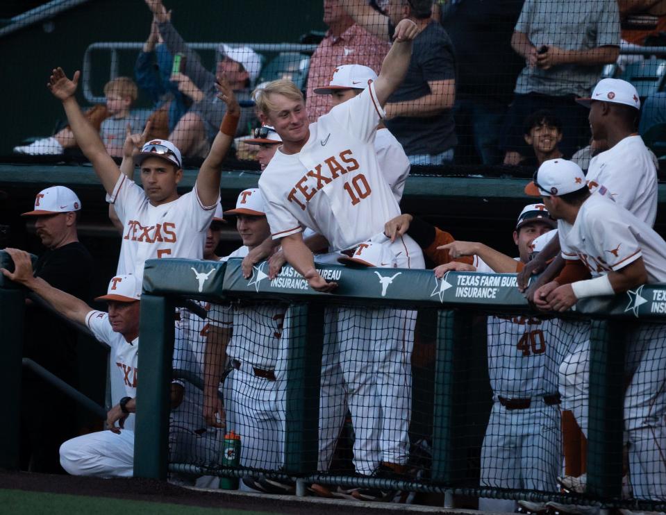 The Texas dugout celebrate a run in the first inning of the Longhorns' game against the Texas State Bobcats at UFCU Disch-Falk Field in Austin, April 11, 2023. 