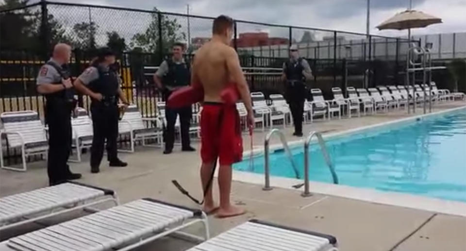 Police watch on before Mateusz Fijalkowski enters the pool. Source: YouTube/Robinhood Esq