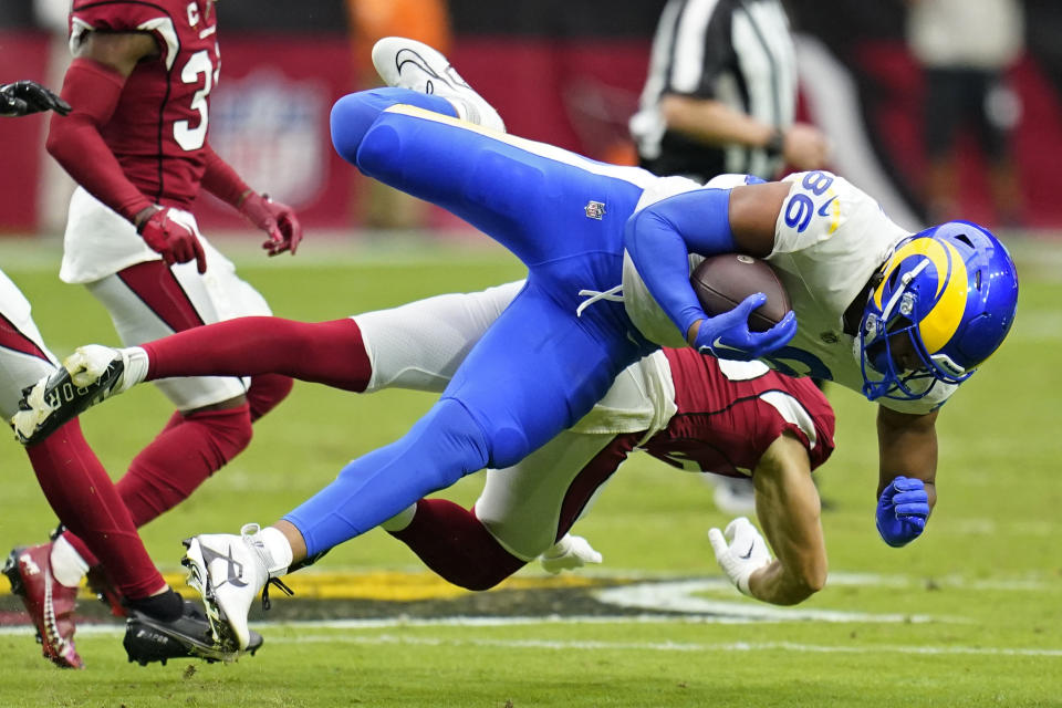 Los Angeles Rams tight end Kendall Blanton (86) is tackled by Arizona Cardinals linebacker Nick Vigil (59) after a first down catch during the first half of an NFL football game, Sunday, Sept. 25, 2022, in Glendale, Ariz. (AP Photo/Ross D. Franklin)