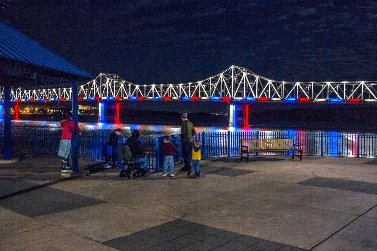 A family gathers in East Peoria to view the lights illuminating the Murray Baker Bridge over the Illinois River.