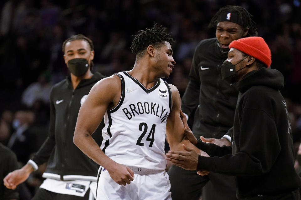 Brooklyn Nets guard Cam Thomas (24) celebrates with forward Kevin Durant, right, after scoring three points in the final seconds of the second half of an NBA basketball game against the New York Knicks, Wednesday, Feb. 16, 2022, in New York. (AP Photo/John Minchillo)