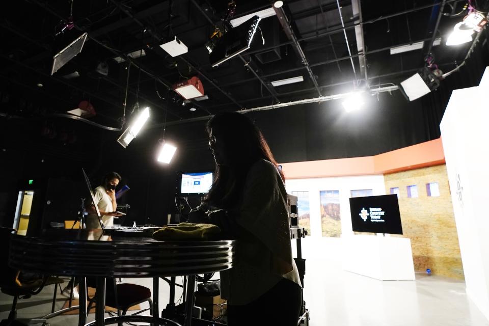 Indian Country Today executive producer and news broadcaster Patty Talahongva, right, works on a computer after a news broadcast taping as video production editor Max Montour, left, stands nearby Friday, Sept. 10, 2021, in Phoenix. Native American communities have seen more robust news coverage in recent years, in part because of an increase in Indigenous affairs reporting positions at U.S. newsrooms and financial support from foundations. (AP Photo/Ross D. Franklin)