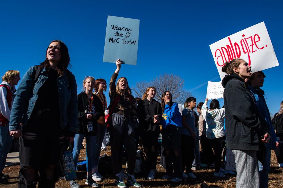 CEC Fort Collins High School student Madison Hansen, center, holds a sign and looks toward Chief Executive Administrator Sandi Brown during a walkout on Thursday. The walkout was a protest of the recent firing of principal Collin Turbert and what they say is corruption in the Colorado Early Colleges system.