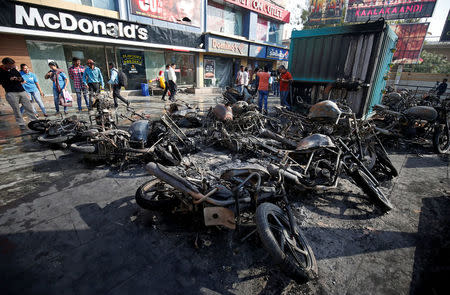 Burnt vehicles, which were set on fire Tuesday night, following a protest by people belonging to Rajput community against the release of the upcoming Bollywood movie "Padmaavat", are pictured outside a multiplex in Ahmedabad, India January 24, 2018. REUTERS/Amit Dave