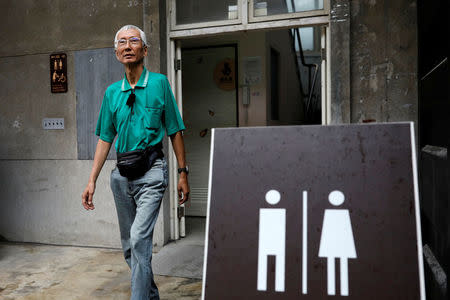 Chi Chia-wei, 59, a gay rights activist, leaves a bathroom in Taipei. "If Taiwan refuses to improve, we will continue our efforts and make a rainbow country. Even a revolution," he said. REUTERS/Tyrone Siu