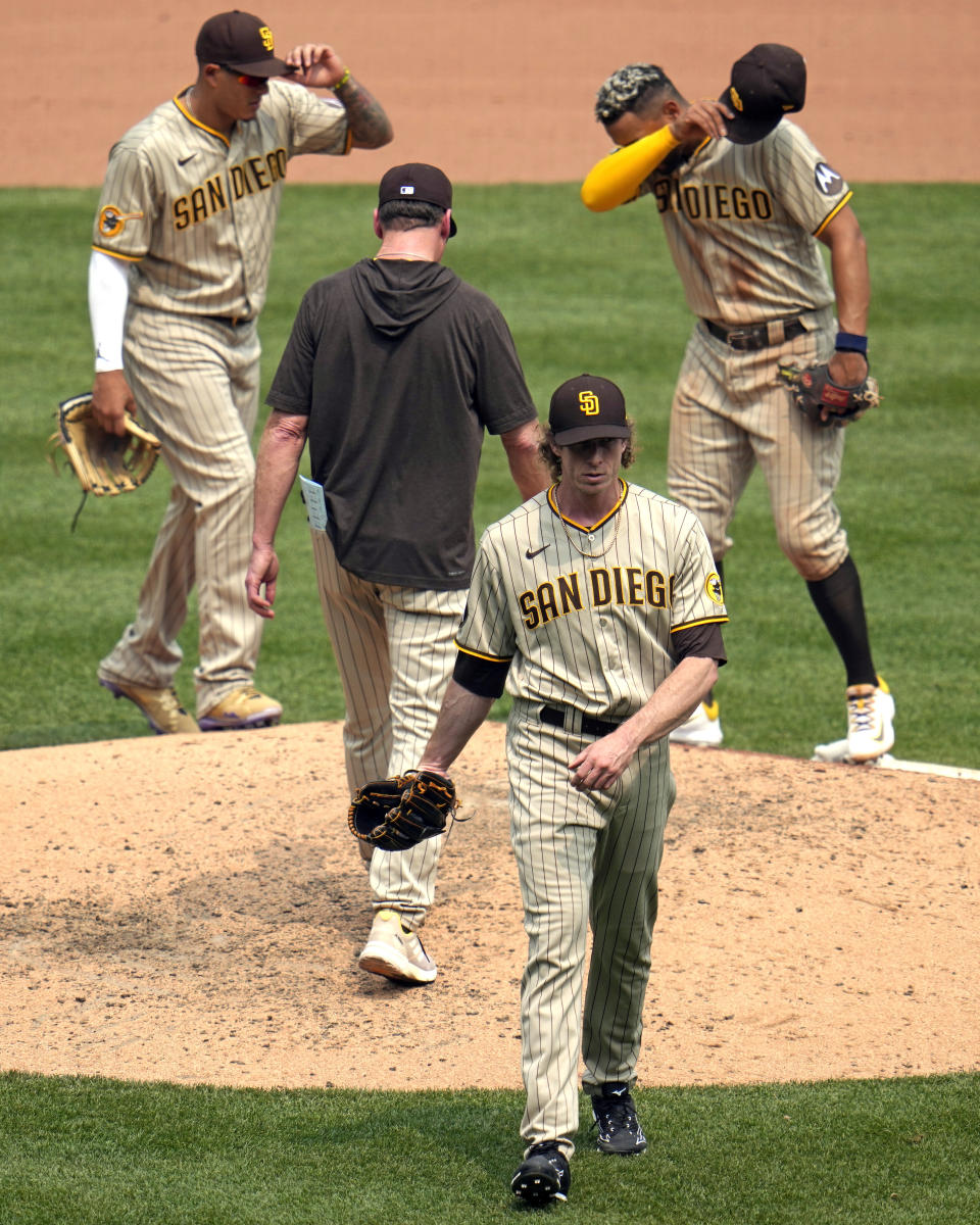 San Diego Padres relief pitcher Tim Hill, bottom center, walks off the mound after being pulled during the seventh inning of a baseball game against the Pittsburgh Pirates in Pittsburgh, Thursday, June 29, 2023. (AP Photo/Gene J. Puskar)