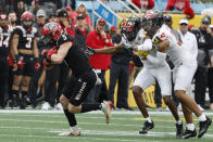 North Carolina State wide receiver Thayer Thomas, left, runs after a catch ahead of Maryland defensive backs Deonte Banks, center, and Beau Brade during the first half of the Duke's Mayo Bowl NCAA college football game in Charlotte, N.C., Friday, Dec. 30, 2022. (AP Photo/Nell Redmond)