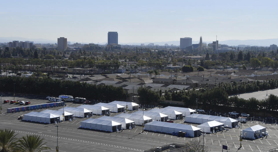 COVID-19 vaccination tents are set up in the north of the Toy Story parking lot at the Disneyland Resort on Tuesday, Jan. 12, 2021, in Anaheim, Calif. The parking lot is located off Katella Avenue and sits southeast of Disneyland. (Jeff Gritchen/The Orange County Register via AP)