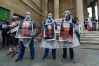 NHS staff covered in fake blood hold posters with depictions of (L-R) Prime Minister Boris Johnson, Secretary of State for Health and Social Care Matt Hancock and Chancellor of the Duchy of Lancaster Michael Gove during a protest outside BBC Broadcasting Housem to demand 15% pay rise for NHS workers on 12 September, 2020 in London, England. Protesters demonstrate against not being included in the government's pay deal for 900,000 public sector workers amid the sacrifices and hardship experienced during the coronavirus pandemic. (Photo by WIktor Szymanowicz/NurPhoto via Getty Images)