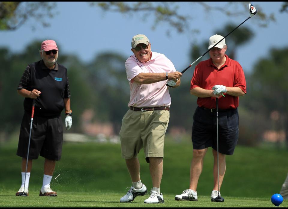 WEST PALM BEACH, FL - MARCH 21:  Rudy Guiliani The former Mayor of New York drives watched by Marvin Shanken and Rush Limbaugh The Radio Presenter during the Els for Autism Pro-am at The PGA National Golf Club on March 21, 2011 in West Palm Beach, Florida.  (Photo by David Cannon/Getty Images)