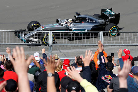 Formula One - Canadian Grand Prix - Montreal, Quebec, Canada - 10/6/16 - Mercedes F1 driver Lewis Hamilton gestures towards the crowd during the first practice. REUTERS/Chris Wattie