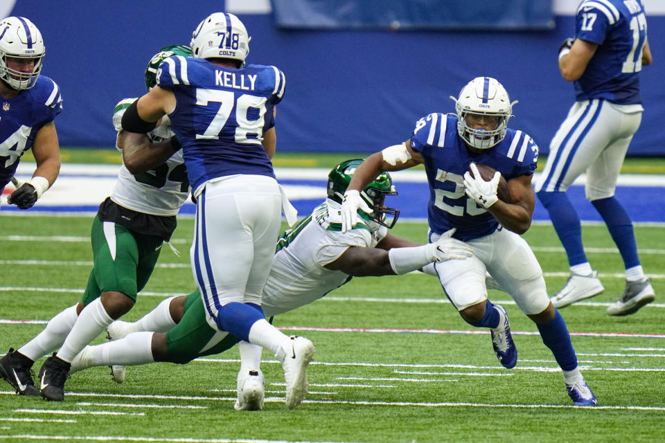 Indianapolis Colts running back Jonathan Taylor (28) breaks the tackle of New York Jets defensive tackle Foley Fatukasi (94) in the second half of an NFL football game in Indianapolis, Sunday, Sept. 27, 2020. (AP Photo/AJ Mast)