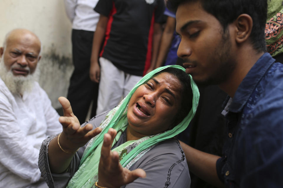 An unidentified Bangladeshi laments following a fire that broke out late Wednesday in closely set buildings in Dhaka, Bangladesh, Thursday, Feb. 21, 2019. A devastating fire raced through at least five buildings in an old part of Bangladesh's capital and killed scores of people. (AP Photo/Rehman Asad)