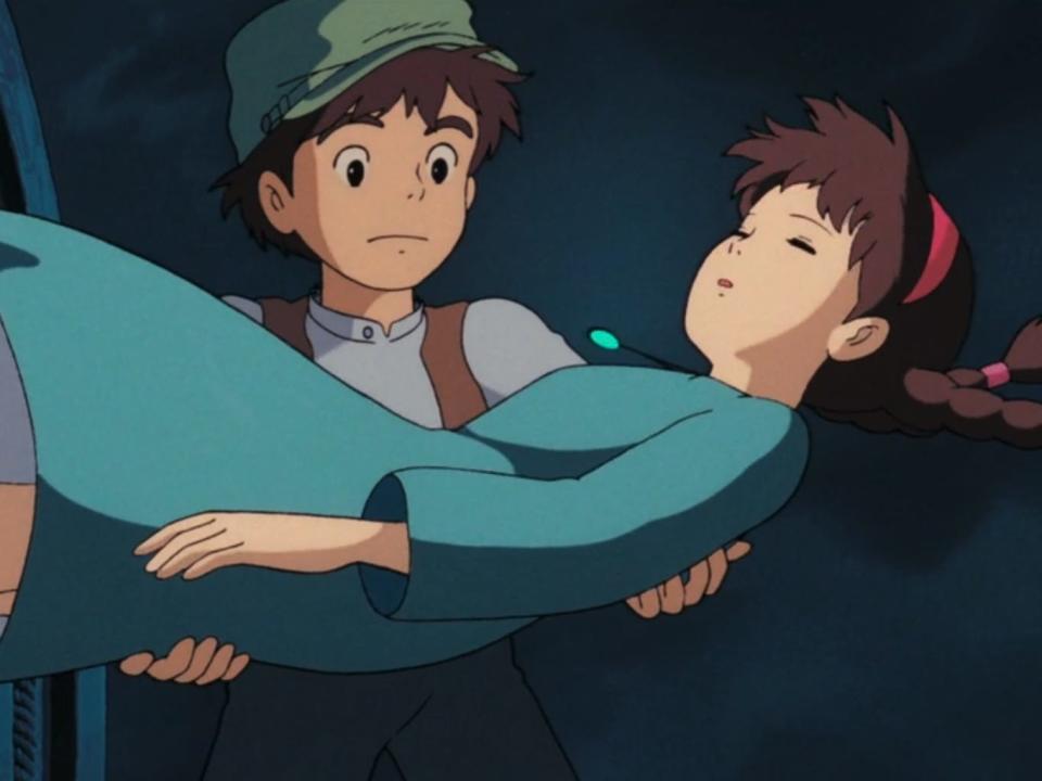 pazu and sheeta in hayao miyazaki's castle in the sky. pazu, a young boy dressed in humble clothes, is lightly cradling sheeta, a young girl wearing a blue dress and with her hair in two braids, as she floats down from the sky. sheeta is unconscious, and there's a blue stone necklace floating slightly above her chest and glowing