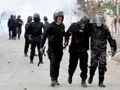 <p>A wounded riot police officer is evacuated during anti-government protests, in Tebourba, south of the Tunisian capital, Tunis, Tuesday, Jan. 9, 2018. (Photo: Anis Ben Ali/AP) </p>