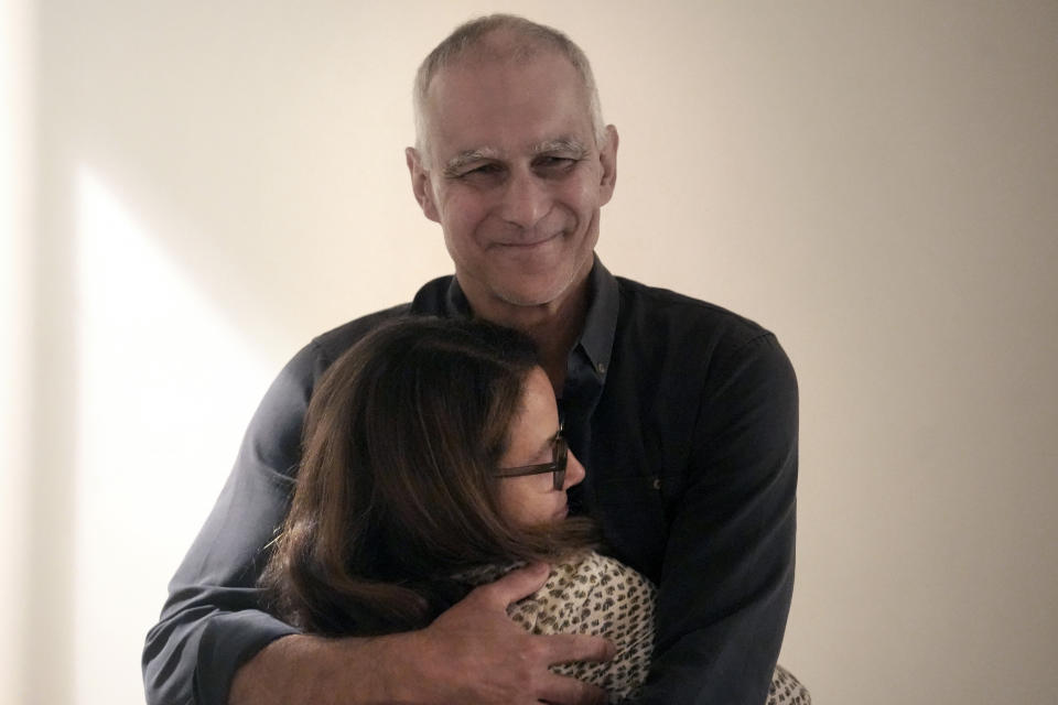 Winner of the 2023 Nobel Prize in Chemistry Massachusetts Institute of Technology scientist Moungi Bawendi, top, embraces his wife Rachel Zimmerman, Wednesday, Oct. 4, 2023, at their home in Cambridge, Mass. (AP Photo/Steven Senne)