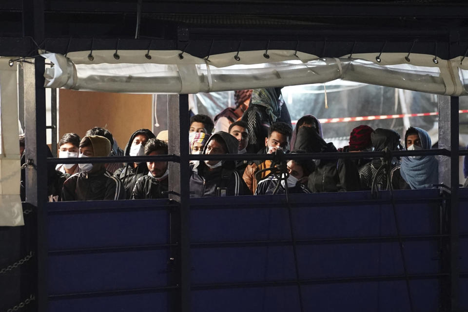 Migrants disembark from the SOS Humanity 1 humanitarian ship in the Italian southern port town of Crotone, Monday, March 4, 2023. German charity SOS Humanity said the Libyan coast guard used violence and fired live bullets as its crew rescued migrants in the Mediterranean Sea on Saturday. The charity said that several migrants aboard three unseaworthy boats had to jump into the water. It said that it rescued 77 people, but that others were forced aboard a coast guard vessel. Some family members were separated and at least one migrant drowned. (Antonino D'Urso/LaPresse via AP )