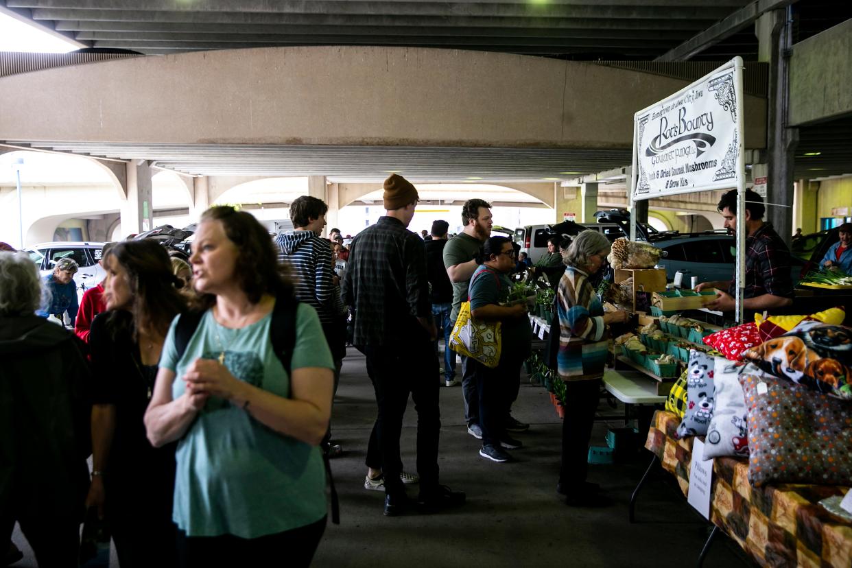 People browse booths during the Iowa City Farmers Market, Saturday, May 6, 2023, at Chauncey Swan Ramp in Iowa City, Iowa.