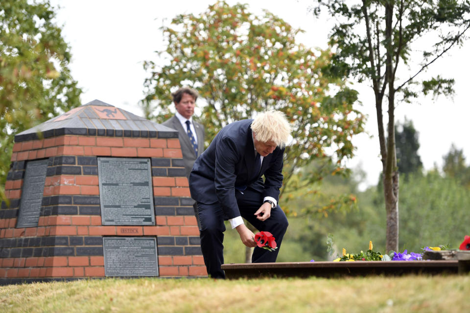 Britain's Prime Minister Boris Johnson lays a wreath at the Royal British Legion Service of Commemoration at the Sumatra Railway Memorial during the national service of remembrance marking the 75th anniversary of V-J Day at the National Memorial Arboretum in Alrewas, England, Saturday Aug. 15, 2020. Following the surrender of the Nazis on May 8, 1945, V-E Day, Allied troops carried on fighting the Japanese until an armistice was declared on Aug. 15, 1945. (Anthony Devlin/PA via AP)