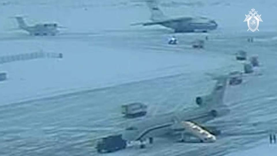 On the photo from video released by Russian Investigative Committee on Friday, Jan. 26, 2024, buses with Ukrainian POWs parked to load Ukrainian servicemen on board of Russian military Il-76 plane, later crashed near Yablonovo, Belgorod region of Russia, on Jan. 25, 2024. Russia's vulnerability to cross-border attacks was highlighted again Wednesday when the Defense Ministry said a military transport plane was shot down in the Belgorod region while carrying Ukrainian prisoners of war. Ukraine didn't contest the plane went down but argued that Moscow had failed to say in advance it was carrying POWs. (Russian Investigative Committee via AP)