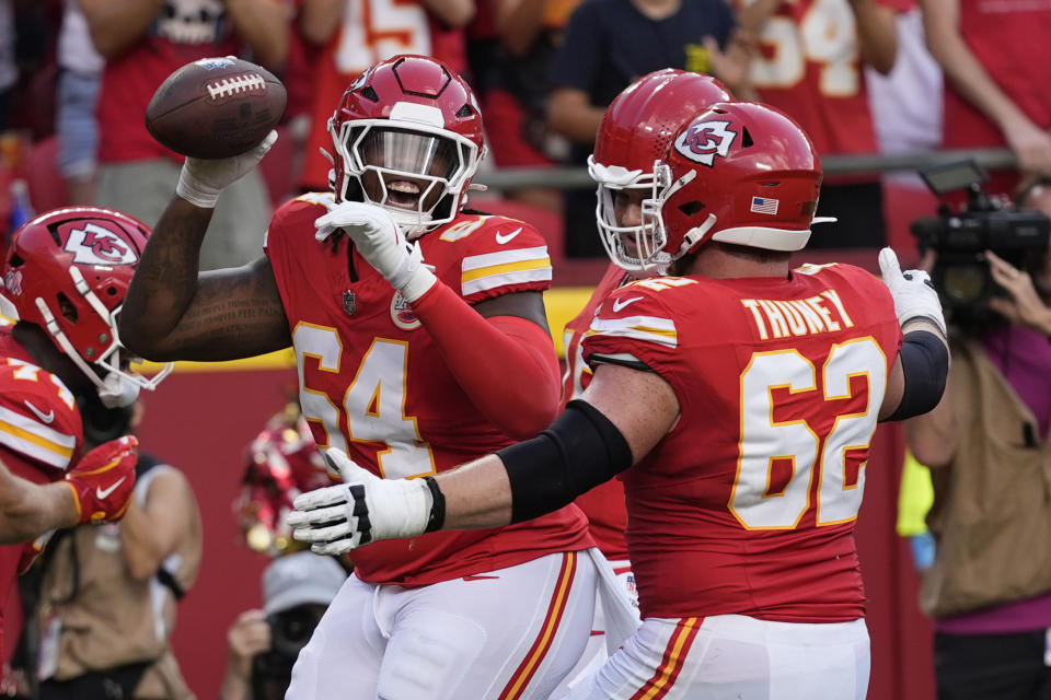 Kansas City Chiefs offensive lineman Wanya Morris, left, is congratulated by teammate Joe Thuney (62) after catching a touchdown pass during the second half of an NFL football game against the Cincinnati Bengals Sunday, Sept. 15, 2024, in Kansas City, Mo. (AP Photo/Ed Zurga)