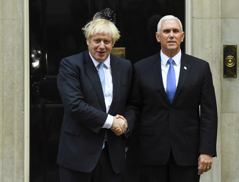 Britain's Prime Minister Boris Johnson, left, greets US Vice President Mike Pence on the doorstep of 10 Downing Street, in London, Thursday, Sept. 5, 2019.(AP Photo/Alberto Pezzali)