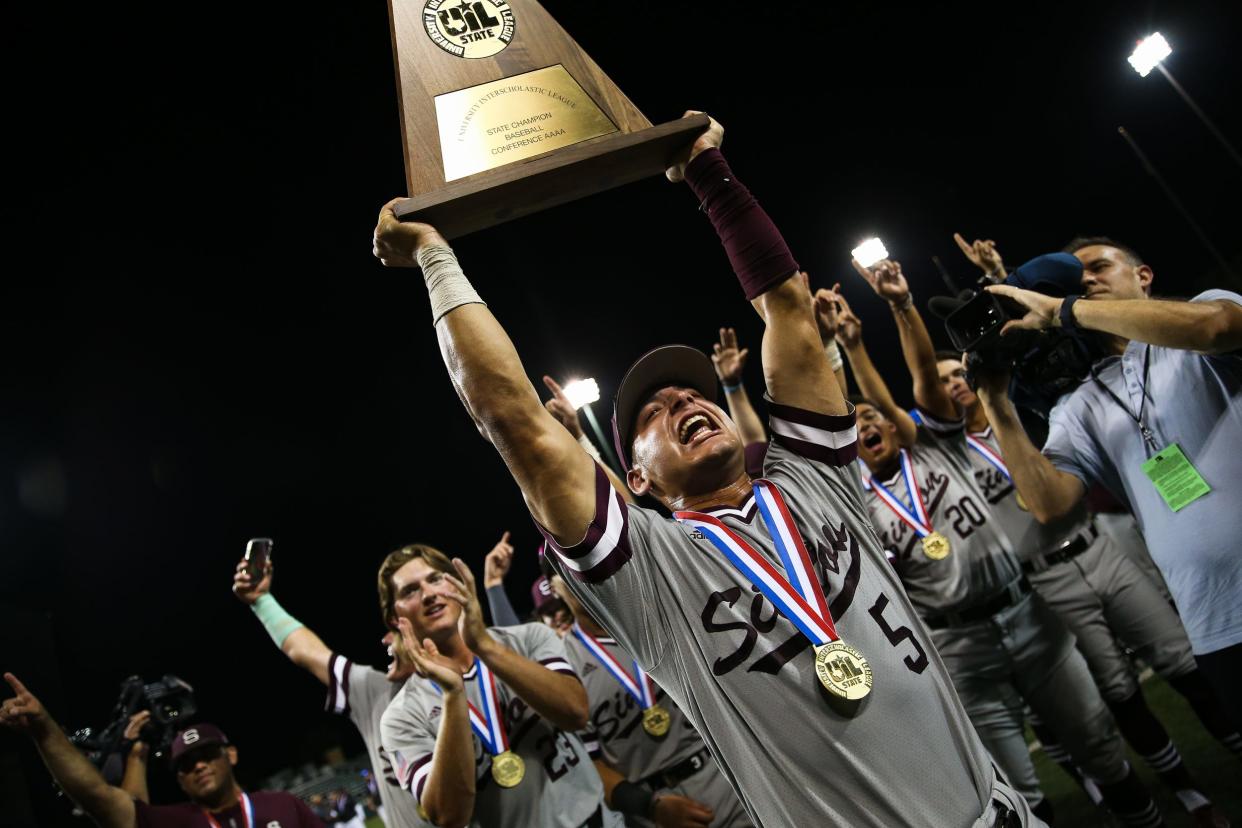 Sinton's Rylan Galvan (5) raises a trophy after winning the UIL Class 4A state championship against Argyle at UFCU Disch-Falk Field on Thursday, June 9, 2022 in Austin, Texas. The Pirates won 9-0, taking the state title for the first time since 2002.