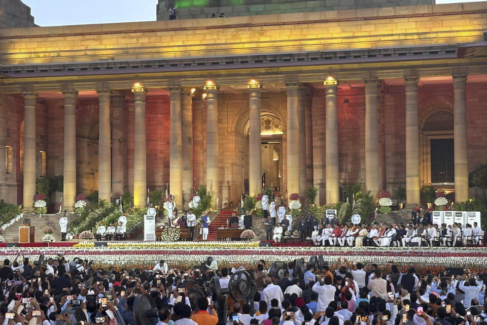 People watch as Narendra Modi takes oath as the Prime Minister of India at the Rashtrapati Bhawan, in New Delhi, India, Sunday, June 9, 2024. The 73-year-old leader is only the second Indian prime minister to retain power for a third term. (AP Photo/Manish Swarup)