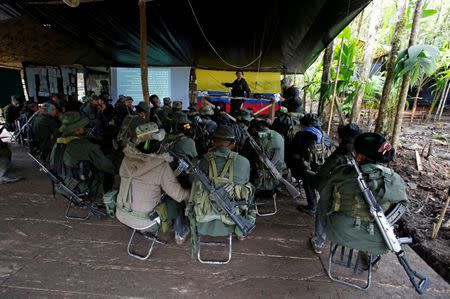 Members of the 51st Front of the Revolutionary Armed Forces of Colombia (FARC) listen to a lecture on the peace process between the Colombian government and their force at a camp in Cordillera Oriental, Colombia, August 16, 2016. REUTERS/John Vizcaino