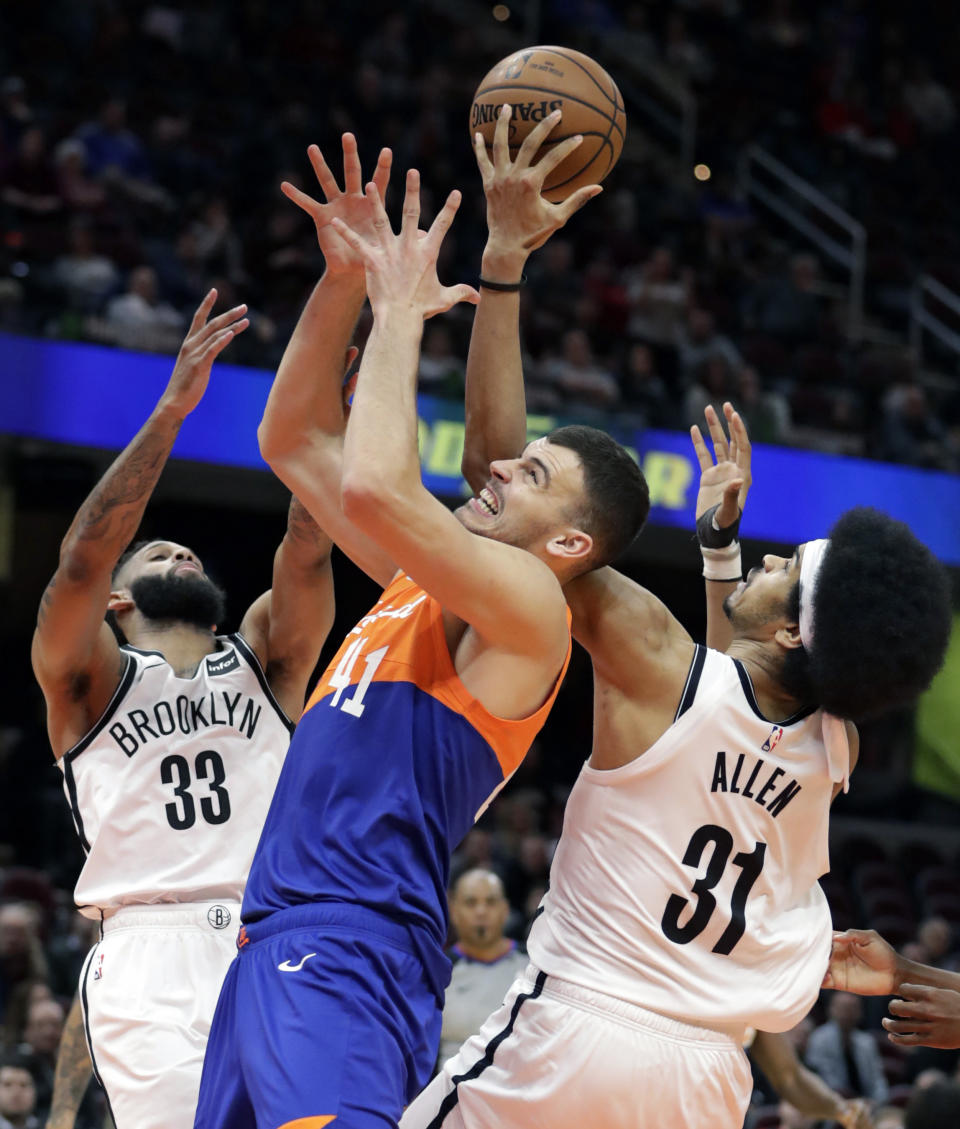 Brooklyn Nets' Allen Crabbe (33), Jarrett Allen (31) and Cleveland Cavaliers' Ante Zizic (41), from Croatia, battle for a loose ball in overtime of an NBA basketball game, Wednesday, Feb. 13, 2019, in Cleveland. Brooklyn won 148-139 in triple-overtime. (AP Photo/Tony Dejak)