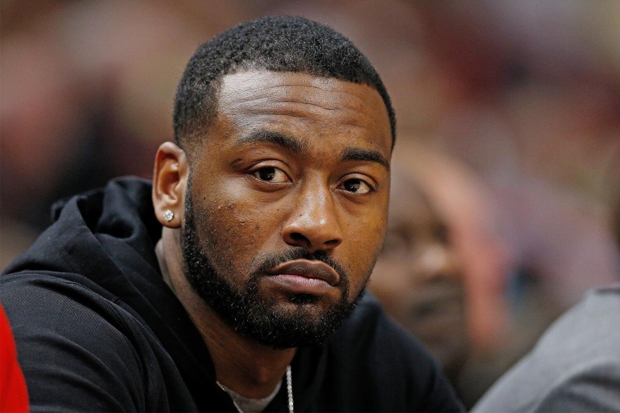 John Wall #2 of the Washington Wizards looks on from the bench against the Miami Heat at American Airlines Arena on January 4, 2019 in Miami, Florida.