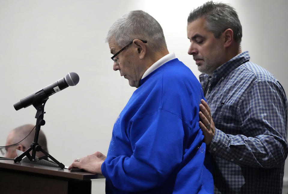 Dave Sorenson, left, the husband of Virginia "Ginny" Sorenson, gives a victim statement as his son Marshall stands by during Darrell Brooks' sentencing in a Waukesha County Circuit Court in Waukesha, Wis., on Tuesday, Nov. 15, 2022. Dozens of people are expected to speak at the sentencing proceedings for Brooks, who is convicted of killing six people and injuring dozens more when he drove his SUV through a Christmas parade in Waukesha last year. (Mike De Sisti/Milwaukee Journal-Sentinel via AP, Pool)