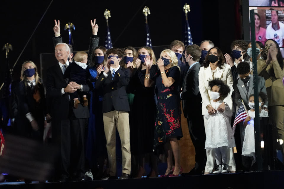 President-elect Joe Biden and Vice President-elect Kamala Harris and their families, watch fireworks on stage in Wilmington, Del., Saturday, Nov. 7, 2020. (AP Photo/Paul Sancya)