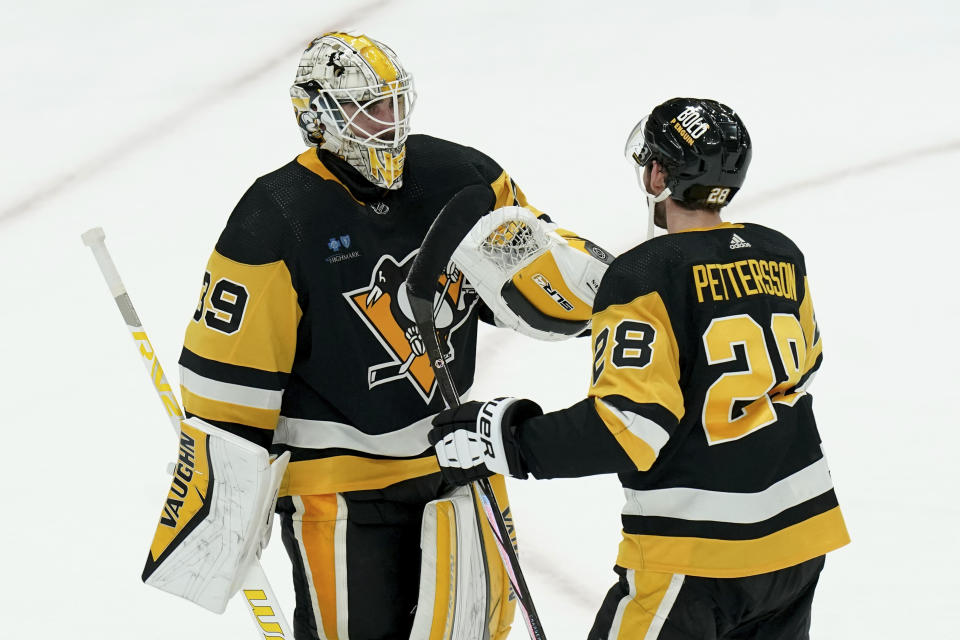 Pittsburgh Penguins' Marcus Pettersson (28) congratulates goaltender Alex Nedeljkovic (39) after defeating the Nashville Predators in an NHL hockey game, Monday, April 15, 2024, in Pittsburgh. (AP Photo/Matt Freed)