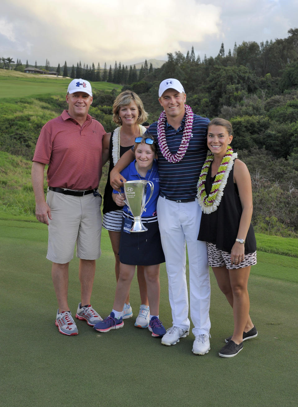 KAPALUA, MAUI, HI - JANUARY 10: Jordan Spieth poses on the 18th green with his mom Chris, father Shawn, sister Ellie and girlfriend Annie Verret after winning the final round of the Hyundai Tournament of Champions at Plantation Course at Kapalua on January 10, 2016 in Kapalua, Maui, Hawaii. (Photo by Stan Badz/PGA TOUR)