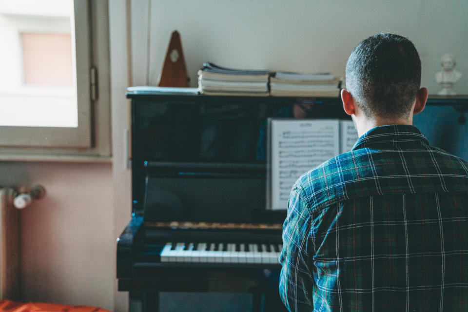 A man is practicing the piano