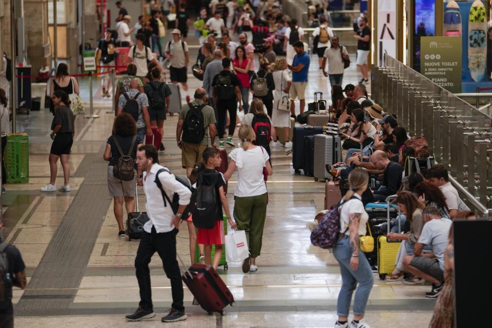 Passengers gather waiting for their train at Milan central station during a national train strike, Thursday, July 13, 2023. Trenitalia and Italo train workers are on strike to demand better working conditions and training. in Milan, Italy, Thursday, July 13, 2023. (AP Photo/Luca Bruno)