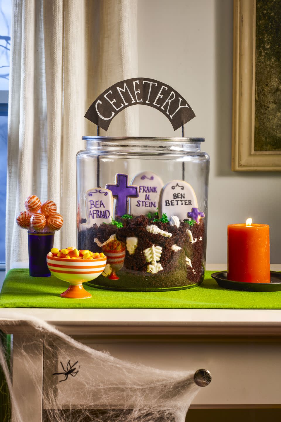 <p>This is one dessert you'll be dying to dig into! Fill a large glass cookie jar chocolate cake crumbs and <a href="https://www.amazon.com/Halloween-Silicone-Skeleton-Decoration-Decorate/dp/B08HRXJXJB?tag=syn-yahoo-20&ascsubtag=%5Bartid%7C10070.g.2586%5Bsrc%7Cyahoo-us" rel="nofollow noopener" target="_blank" data-ylk="slk:white chocolate bones;elm:context_link;itc:0;sec:content-canvas" class="link ">white chocolate bones</a>. Use a <a href="https://www.amazon.com/Tombstone-Cookie-Cutter-Stainless-Steel/dp/B07HLVMBV7/?tag=syn-yahoo-20&ascsubtag=%5Bartid%7C10070.g.2586%5Bsrc%7Cyahoo-us" rel="nofollow noopener" target="_blank" data-ylk="slk:tombstone cookie cutter;elm:context_link;itc:0;sec:content-canvas" class="link ">tombstone cookie cutter</a> to make sugar cookies and decorate with royal icing. Pipe in tufts of grass using green-tinted <a href="https://www.womansday.com/food-recipes/food-drinks/recipes/a10410/buttercream-frosting-recipe-122427/" rel="nofollow noopener" target="_blank" data-ylk="slk:buttercream;elm:context_link;itc:0;sec:content-canvas" class="link ">buttercream</a>, then push a DIY cemetery sign made from card stock and painted wood skewers for a finishing touch.</p><p><a href="https://www.womansday.com/food-recipes/food-drinks/recipes/a12008/basic-sugar-cookies-recipe-wdy1212/" rel="nofollow noopener" target="_blank" data-ylk="slk:Get the Basic Sugar Cookie recipe.;elm:context_link;itc:0;sec:content-canvas" class="link "><strong><em>Get the Basic Sugar Cookie recipe.</em></strong></a></p>