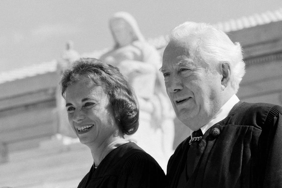 FILE - Sandra Day O'Connor and Chief Justice Warren Burger pose for pictures at the U.S. Supreme Court building in Washington, Sept. 25, 1981. O'Connor will be sworn in as the first female justice of the Supreme Court later this afternoon. O'Connor, who joined the Supreme Court in 1981 as the nation's first female justice, has died at age 93. (AP Photo, File)