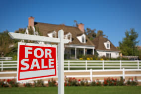 Home For Sale Real Estate Sign in Front of New House.