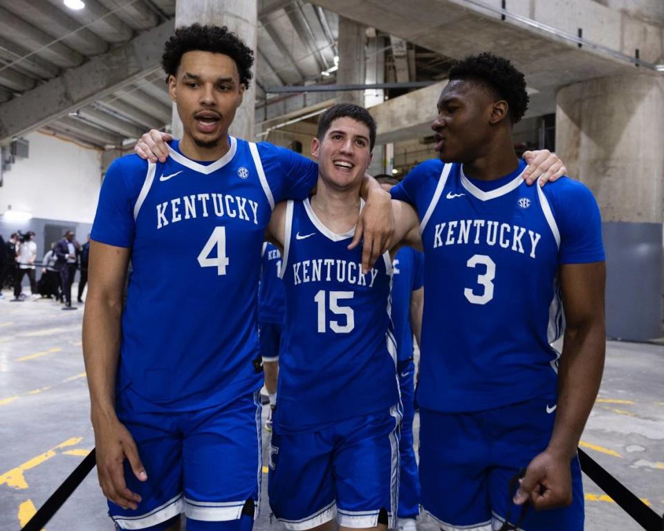 Kentucky’s Tre Mitchell, left, Reed Sheppard and Adou Thiero celebrate in the back hallways of Thompson-Boling Arena after their team’s win against Tennessee in Knoxville. Chet White/UK Athletics