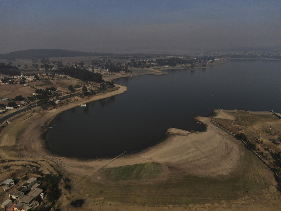 An aerial view of Villa Victoria Dam, the main water supply for Mexico City residents, on the outskirts of Toluca, Mexico Thursday, April 22, 2021. Drought conditions now cover 85% of Mexico, and in areas around Mexico City and Michoacán, the problem has gotten so bad that lakes and reservoirs are drying up. (AP Photo/Fernando Llano)