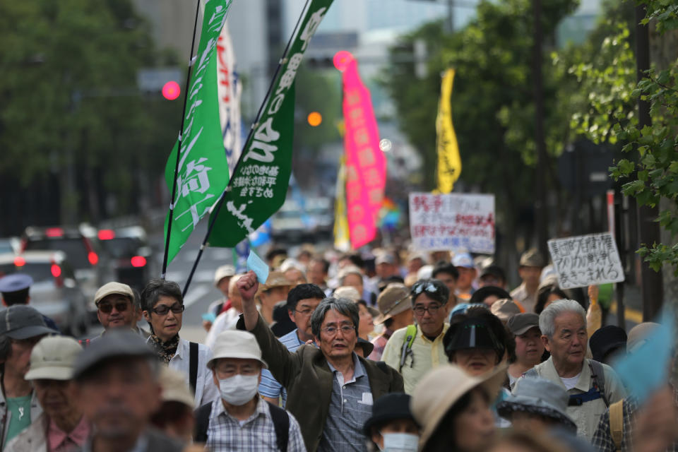 Hundreds of people march vowing to protect the constitution in Tokyo, Saturday, May 3, 2014. Japan marked the 67th anniversary of its postwar constitution Saturday with growing debate over whether to revise the war-renouncing charter in line with Prime Minister Shinzo Abe's push for an expanded role for the military. (AP Photo/Eugene Hoshiko)