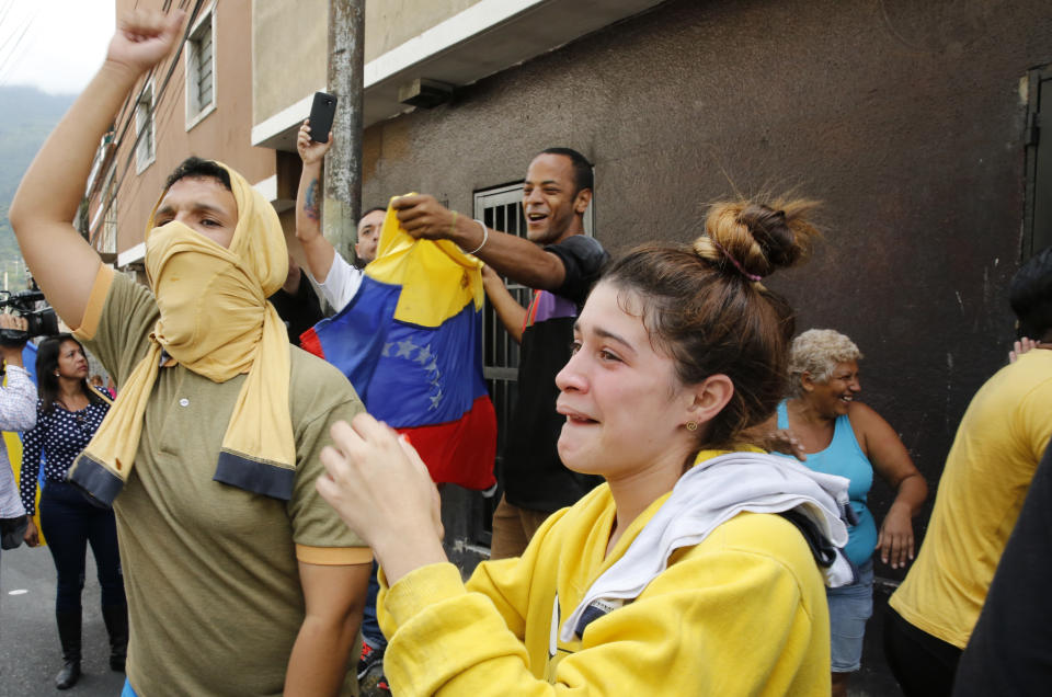 Anti-government protesters show support for an apparent mutiny by a national guard unit in the Cotiza neighborhood of Caracas, Venezuela, Monday, Jan. 21, 2019. (AP Photo/Ariana Cubillos)