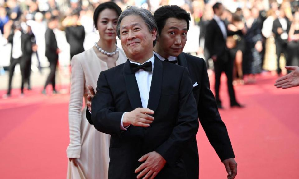 Director Park Chan-wook with Decision to Leave stars Park Hae-il and Tang Wei.