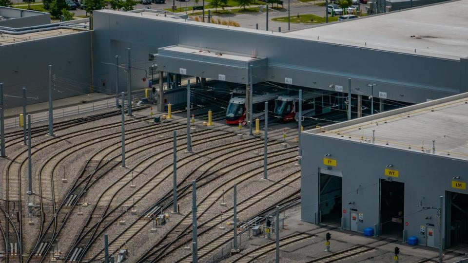 Ottawa light rail trains peek out of an OC Transpo maintenance garage Aug. 1, 2023. This photo was taken using a drone.