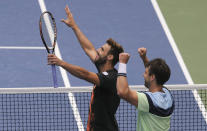 Marcel Granollers, of Spain, left, and doubles partner Horacio Zeballos, of Argentina, react after winning a semifinal doubles match against Kevin Kawietz and Andreas Mies, of Germany, at the U.S. Open tennis championships Thursday, Sept. 5, 2019, in New York. (AP Photo/Charles Krupa)