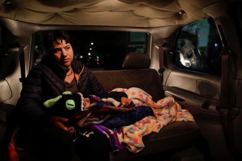 Esperanza Paz holds her son, Hermes Soto, as they go to the hospital in Mexico City