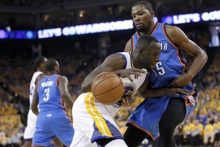 May 26, 2016; Oakland, CA, USA; Golden State Warriors forward Draymond Green (23) loses control of the ball as Oklahoma City Thunder forward Kevin Durant (35) defends in the first quarter in game five of the Western conference finals of the NBA Playoffs at Oracle Arena. Mandatory Credit: Cary Edmondson-USA TODAY Sports